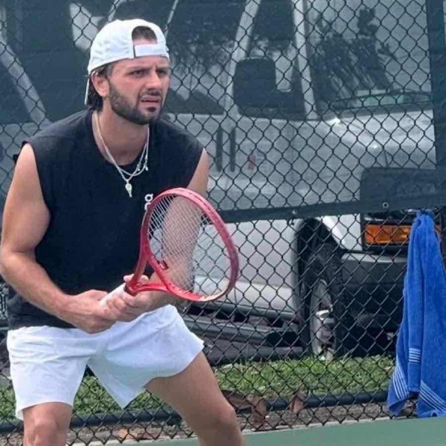 Hitting partner Guillerme Valle in a ready position on court